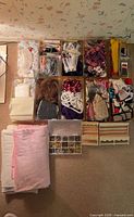 Overview of trays containing trims, ribbons, fabric, wooden shelves and organizer boxes