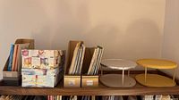 Overview of storage boxes, magazine holders and two-tier stands on shelf