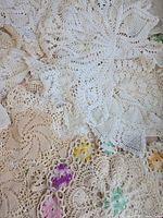 Assorted cream and white crocheted doilies with lace patterns