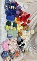 Full layout of 60+ skeins arranged by color on sofa