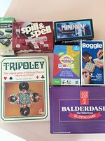 Seven boxed games visible: Tripoley, Spill & Spell, MindTrap, Boggle, Cranium Dice, Dominoes, Balderdash