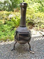 Full view of cast iron chiminea on patio
