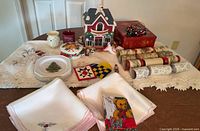 Wide view of all Christmas decor, linens, figurine, crackers, tin, plates and ornaments on table
