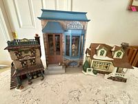 All three miniature village buildings on table