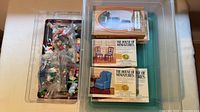 Overall lot in two plastic bins showing boxed kits and bagged figurines