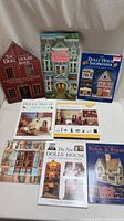 Group shot of eight dollhouse books showing titles and covers