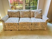 Front view of Drexel 3-seater sofa showing rolled arms, floral fabric, cushions, skirted base