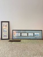 Both framed nautical prints standing against wall showing full view of items