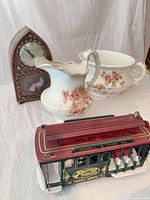 Group shot showing Goodwin floral pitcher, matching bowl, Haddon clock, cable car music box