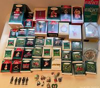 Stacked Hallmark and Schmid ornament boxes with loose figurines front