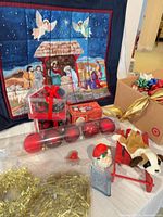 Overall lot showing wall hanging, ornaments, tinsel, plush dog on sled, boxed mugs