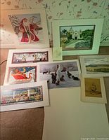 All nine artworks laid out showing variety of subjects and sizes