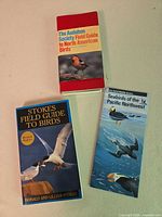 All three bird guides laid out, covers visible