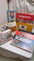 All eight boxed games and paper doll set grouped together