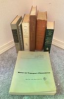 Seven books grouped; titles and bindings visible including Notes on Transport Phenomena front
