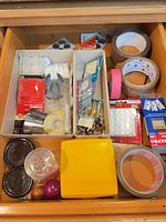 Drawer overview showing tapes, trays with small hardware, knobs, batteries, blades