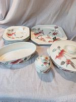 Stacks of dinner and salad plates plus serving pieces displayed