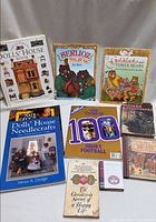 Group shot of all nine books and magazine