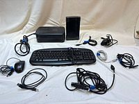 Group shot showing all items: keyboard, mouse, APC UPS, hard drive enclosure, multiple cables