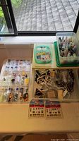Table view of paints, cords, organizers and miniatures