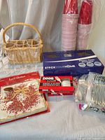 Group shot showing wicker carrier, paper cups stack, StockYourHome cutlery box, Disco Cutlery pack, lace doilies and loose cutlery