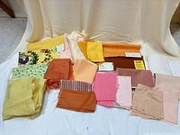 assorted fabric pieces laid out showing variety of colors and patterns