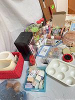 Overview of lot showing Barbie ornament box, craft supplies, porcelain vases, shell, palette and accessories