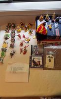 Full lot on table showing ornaments, CDs, envelope box and craft sheets