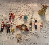 Selection of various ornaments laid out including nutcrackers, angel, snowflakes, house and wreath