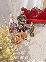 Group view of sofa, baskets, dolls and figurines