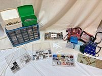 Overall lot showing bead cabinet, two small bead boxes, three clear compartment boxes, assortment of beads, and group of small bags/pouches