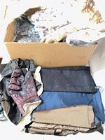 Overview of box with gloves, fabric remnants and fur pieces