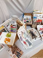 Multiple boxes and stacks of vintage sewing pattern envelopes