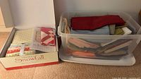 Snowfall kit box opened next to clear tote of assorted fabric