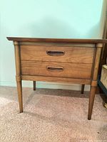 Front and side view of one nightstand showing overall design and condition