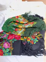 Stack showing both floral shawls and one white throw
