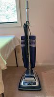 Front view of Sanitaire upright vacuum showing full unit