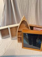 Group of five wood shadow boxes and rowboat shelf