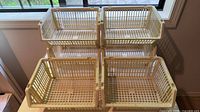 Six beige plastic lattice baskets stacked in two tiers