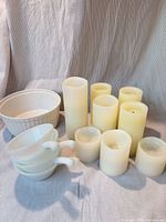 Group view of ceramic bowl, stacked milk-glass bowls, and eight LED candles