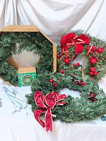 Three wreaths, one boxed, showing sizes, bows, berries, lights