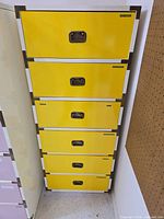 Front view showing all six yellow drawers closed