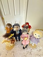 Front group view of all six dolls with accessories