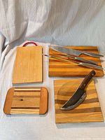 Overall view of four cutting boards and four knives/utensils