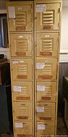 Front view of both tall locker cabinets showing 12 doors and yellow-cream finish