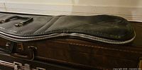 Exterior view of black Cooper long gun case showing contour shape and zipper