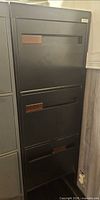 Full front view of black four-drawer filing cabinet