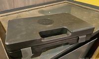 Closed black Norinco pistol case, top view showing handle and latches