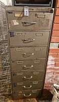 Full frontal view of cabinet showing seven drawers and hasp lock