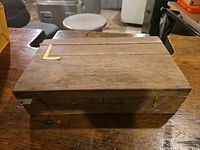 Closed wooden box top view with L-shaped inlay